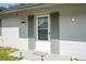 Charming front entrance with a white door, decorative shutters, and a 'Welcome' mat at 14796 Sw 39Th Cir, Ocala, FL 34473