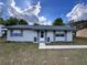 Charming single story home with a well-maintained lawn, lovely front door and gray shutters at 14796 Sw 39Th Cir, Ocala, FL 34473