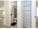 Hallway view of bathroom with shower/tub combo plus closet with wire shelving at 14796 Sw 39Th Cir, Ocala, FL 34473