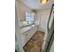 Bright kitchen with white cabinets, neutral countertops, double sink and a patterned floor mat at 14796 Sw 39Th Cir, Ocala, FL 34473