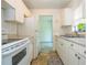Bright kitchen features white cabinets, appliances, and a view to the next room at 14796 Sw 39Th Cir, Ocala, FL 34473