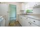 Bright kitchen featuring white cabinets, stainless steel sink, and view to the next room at 14796 Sw 39Th Cir, Ocala, FL 34473