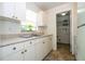 Well-lit kitchen with white appliances and ample cabinet space at 14796 Sw 39Th Cir, Ocala, FL 34473
