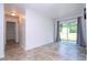 Living room with neutral tile and sliding glass doors to backyard at 14796 Sw 39Th Cir, Ocala, FL 34473