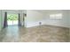 Open living area featuring tile floors, sliding glass doors, and natural light for a welcoming space at 14796 Sw 39Th Cir, Ocala, FL 34473
