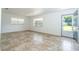 Bright living room with neutral tile, natural light from windows, and an open entry doorway at 14796 Sw 39Th Cir, Ocala, FL 34473
