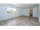 Bright living room with neutral tile floors, a window, and a view into the hallway at 14796 Sw 39Th Cir, Ocala, FL 34473