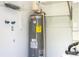 Utility room with modern water heater, plumbing, and ample shelving at 14796 Sw 39Th Cir, Ocala, FL 34473