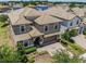 An aerial view showcases this two-story home with a tile roof, brick driveway, and well-manicured landscaping at 1491 Rolling Fairway Dr, Davenport, FL 33896