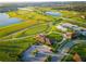 Stunning aerial view of the golf course, lakes, and roads within the community at 1491 Rolling Fairway Dr, Davenport, FL 33896