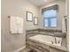 Bright bathroom with a soaking tub, decorative tile, and elegant bronze fixtures at 1491 Rolling Fairway Dr, Davenport, FL 33896