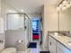 Modern bathroom features a single granite vanity, sleek lighting, and a glass-enclosed shower at 1491 Rolling Fairway Dr, Davenport, FL 33896