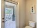 Cozy bathroom featuring a modern toilet and a sliding glass door leading to an outdoor patio at 1491 Rolling Fairway Dr, Davenport, FL 33896