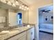 Modern bathroom features a single granite vanity, sleek lighting, and entry to bedrooms at 1491 Rolling Fairway Dr, Davenport, FL 33896