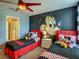 Charming themed bedroom with custom Mickey Mouse wall art and twin beds at 1491 Rolling Fairway Dr, Davenport, FL 33896