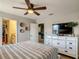 Bedroom featuring light-colored walls, white dresser, and doorway to bath at 1491 Rolling Fairway Dr, Davenport, FL 33896