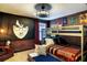 Charming themed bedroom with bunk beds, red brick wall, and Harry Potter decorative art at 1491 Rolling Fairway Dr, Davenport, FL 33896