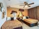 Themed bedroom with safari wall mural, twin beds with animal print bedding, and unique decor at 1491 Rolling Fairway Dr, Davenport, FL 33896