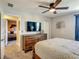 Comfortable bedroom featuring neutral tones, TV and view into another bedroom at 1491 Rolling Fairway Dr, Davenport, FL 33896