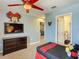 Bedroom featuring a recessed TV with a Mickey Mouse theme, and a door to the bathroom at 1491 Rolling Fairway Dr, Davenport, FL 33896