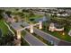 Scenic aerial view of the ChampionsGate entrance with lush landscaping, fountain, and guard house at 1491 Rolling Fairway Dr, Davenport, FL 33896