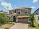 Charming two-story home featuring a tile roof, two-car garage, and landscaped front yard, perfect for families at 1491 Rolling Fairway Dr, Davenport, FL 33896