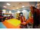 Vibrant game room featuring a variety of arcade games and bright, colorful flooring at 1491 Rolling Fairway Dr, Davenport, FL 33896