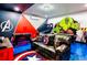 Vibrant game room featuring themed decor, foosball, air hockey, and a comfortable lounge area for endless entertainment at 1491 Rolling Fairway Dr, Davenport, FL 33896