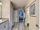 Hallway connecting the bathroom and bedrooms, featuring stylish flooring and modern decor at 1491 Rolling Fairway Dr, Davenport, FL 33896