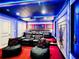 Immerse yourself in entertainment with this home theater featuring plush seating, projector, and cool lighting at 1491 Rolling Fairway Dr, Davenport, FL 33896