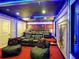 Experience movie nights in this home theater featuring comfortable seating and custom lighting at 1491 Rolling Fairway Dr, Davenport, FL 33896