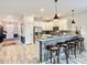 Modern kitchen with white cabinets, stainless steel appliances, granite countertops, and stylish breakfast bar seating at 1491 Rolling Fairway Dr, Davenport, FL 33896