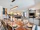Open-concept living and dining area featuring a large dining table, modern lighting, and comfortable seating at 1491 Rolling Fairway Dr, Davenport, FL 33896