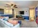 Upstairs living room featuring neutral carpet, a wall-mounted TV, and easy access to the bedrooms and bathroom at 1491 Rolling Fairway Dr, Davenport, FL 33896