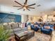 Open-concept living room showcasing comfortable seating, a modern dining area, and a convenient breakfast bar at 1491 Rolling Fairway Dr, Davenport, FL 33896