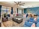 Spacious living room featuring a plush sectional, stylish armchairs, and an open floor plan with dining area access at 1491 Rolling Fairway Dr, Davenport, FL 33896