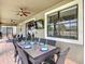 Outdoor dining area with seating for eight, ceiling fans and a view of the pool at 1491 Rolling Fairway Dr, Davenport, FL 33896
