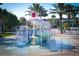 Community pool with water slides, bucket drop and poolside seating at 1491 Rolling Fairway Dr, Davenport, FL 33896