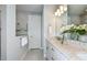 Modern bathroom featuring double sinks, granite countertops, a walk-in shower, and neutral tile flooring at 15148 Willow Ridge Dr, Montverde, FL 34756
