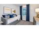 Cozy bedroom featuring a comfortable daybed, modern artwork, and a window with blue drapes at 15148 Willow Ridge Dr, Montverde, FL 34756