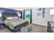 Cozy bedroom with blue accent wall, surfboard decor, and view of lush greenery from the window at 15148 Willow Ridge Dr, Montverde, FL 34756