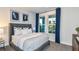 Inviting bedroom with large windows providing ample natural light, complemented by stylish decor at 15148 Willow Ridge Dr, Montverde, FL 34756