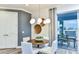 Bright dining area featuring modern lighting, stylish furniture, and a view to the patio at 15148 Willow Ridge Dr, Montverde, FL 34756
