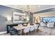 Modern dining room featuring contemporary chandelier, stylish furniture, and a view to living area at 15148 Willow Ridge Dr, Montverde, FL 34756