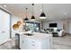 Open-concept kitchen featuring a central island, stainless appliances, and seamless flow to the living room at 15148 Willow Ridge Dr, Montverde, FL 34756
