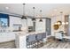 Modern kitchen featuring a central island, stainless appliances, and stylish pendant lighting above the bar seating at 15148 Willow Ridge Dr, Montverde, FL 34756