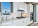 Well-equipped kitchen with stainless steel appliances, gas range, white cabinetry, and granite countertops at 15148 Willow Ridge Dr, Montverde, FL 34756