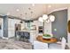 Bright kitchen featuring a large island, modern lighting, stainless steel appliances and ample cabinet space at 15148 Willow Ridge Dr, Montverde, FL 34756