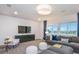 Relaxing living room with plush seating, modern shiplap wall, and scenic views, perfect for gatherings at 15148 Willow Ridge Dr, Montverde, FL 34756