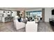 Inviting living room with modern furniture, large windows, and seamless flow to the kitchen at 15148 Willow Ridge Dr, Montverde, FL 34756